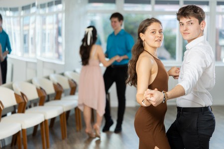 During rehearsal, guy and girl participants of dance workshop perform social pair danceの写真素材