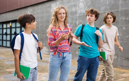 Group of four teens going home from schoolの写真素材
