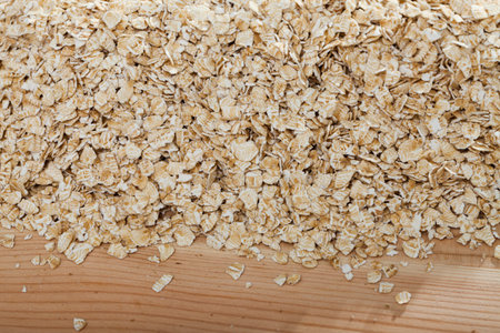 Cereals and healthy eating concept - oatmeal flakes. Natural background