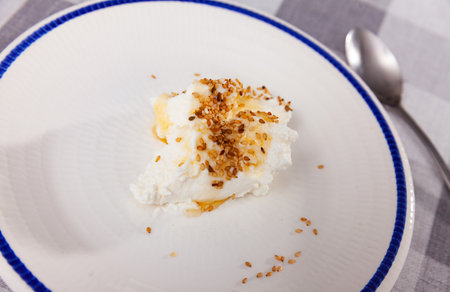 Homemade hearty breakfast - cottage cheese with honey sauce. dish is richly decorated with sesameの写真素材