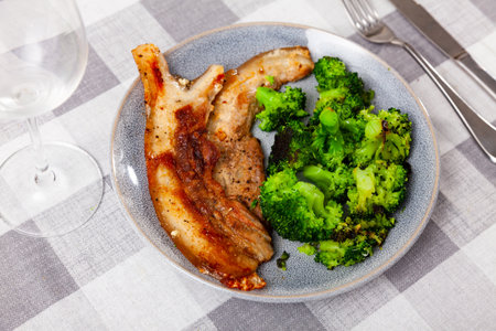 Roasted pork belly served with broccoliの写真素材