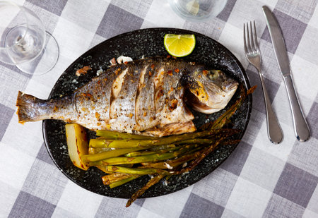 Dorada fish served with potatoes and asparagusの写真素材