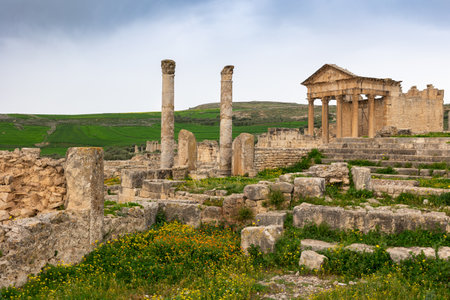 Remains of Capitol Temple of Dougga in Tunisia under cloudy skyの写真素材