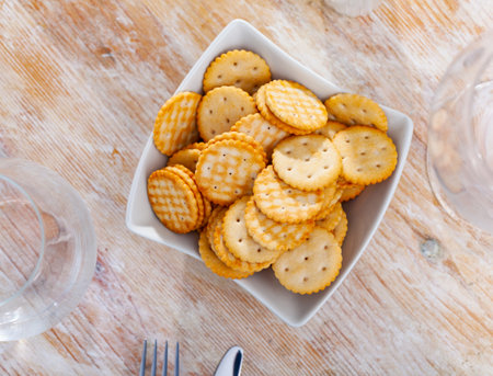 Bowl with thin round crackers with saltの写真素材