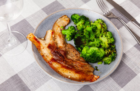 Roasted pork belly served with broccoliの写真素材