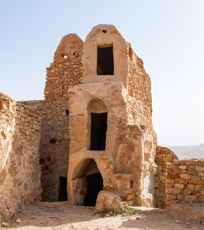 Ruins of ancient Berber fortified Ksar Beni Barka located in Tataouine Governorate in southern Tunisia with stone remains of dwelling and storing roomsの写真素材