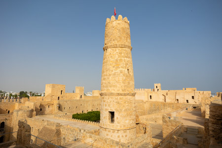 Sunlit Ribat of Monastir, ancient Islamic fortress, displaying strategic architectural structures and sturdy stone construction of fortifications and watchtower in Tunisiaの写真素材