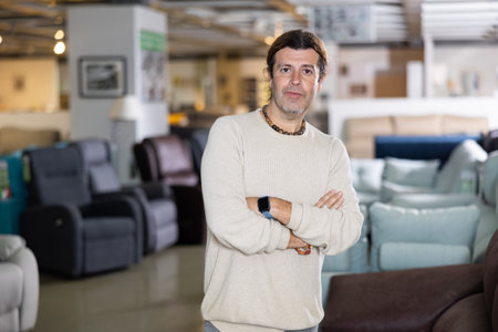 Middle-aged man in a furniture store chooses a new sofaの写真素材