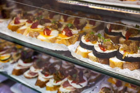 Pinchos with morcilla and creamy cheese in deli caseの写真素材