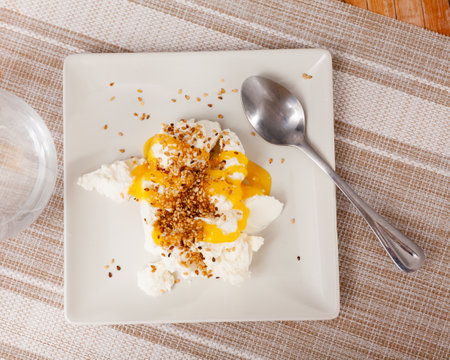 Homemade hearty breakfast - cottage cheese with honey sauce. dish is richly decorated with sesameの写真素材