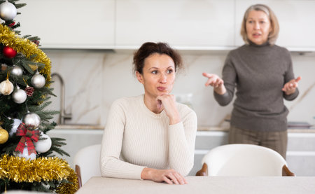 Domestic quarrel between mother and daughter during Christmas celebrationの写真素材