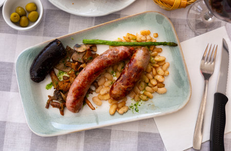 Catalan dish with baked sausages, fried beans, mushrooms and asparagusの写真素材
