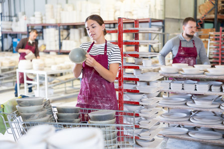 Young woman posing with ceramic dishesの写真素材