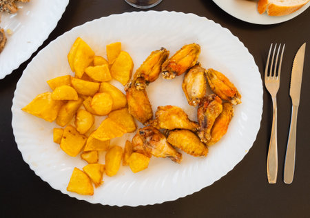 Tasty chicken wings with with gravy and potatoesの写真素材