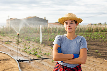 Portrait of a confident female farmer in front of farmの写真素材