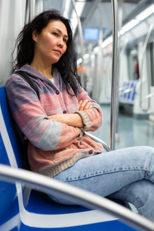 Young woman passenger sitting in subway carの写真素材