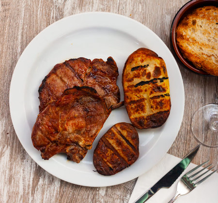 Delicious pork chop with potatoes and parsley