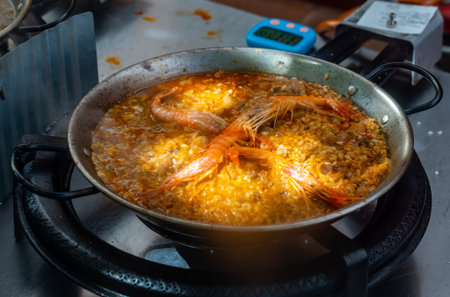 Process of cooking seafood paella in large frying panの写真素材