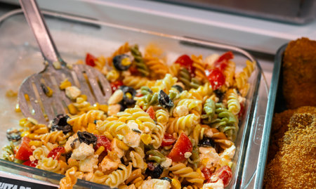 Pasta and pesto salad displayed in deli section of local storeの写真素材