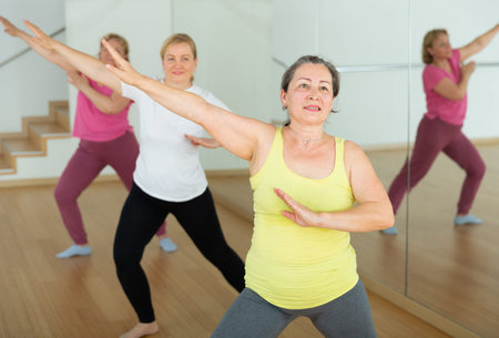 Mature women warming up before dance training