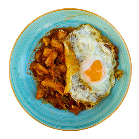 Rich cod stew in garlic and tomato salsa with fried eggの写真素材