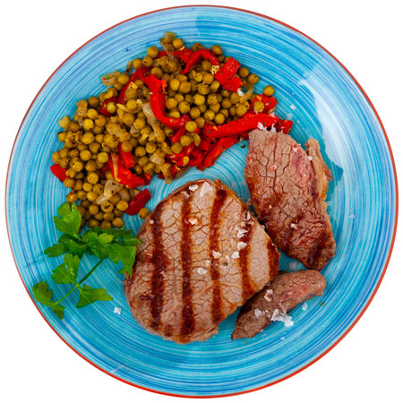 Fried beef served with peas and peppersの写真素材