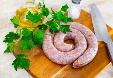 There is ring of homemade raw sausage made from meat mixの写真素材