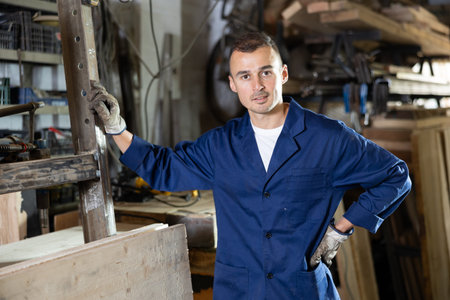 Portrait of professional male worker during work with steel in workshop