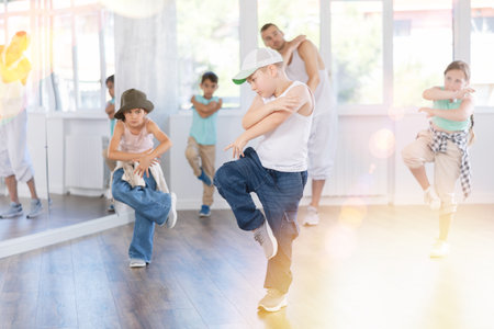 Tween boy dancer rehearsing krump dance in kids studioの写真素材