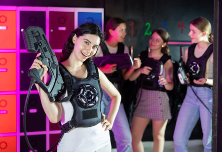 Cheerful and happy girl pose in locker room before laser tag match.の写真素材