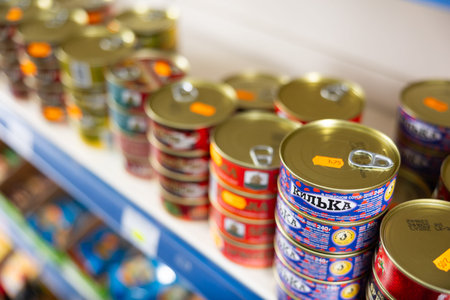 Russian goods store shelves have wide range of canned sprats in oil and tomato sauce