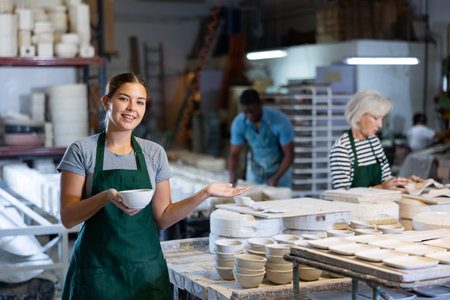 Female potter arrange pottery plate at factory ceramicの写真素材
