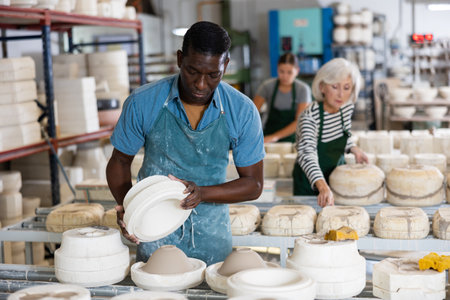 Skillful man ceramist crafring crockeryの写真素材