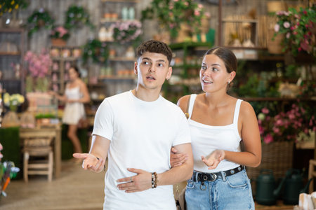 Young couple looking for garden furniture in home decor store