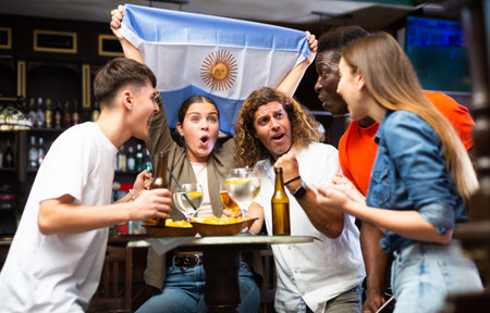 Group of Argentina football team fans spending time in barの写真素材