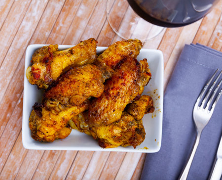Tasty crispy grilled chicken wings on plateの写真素材
