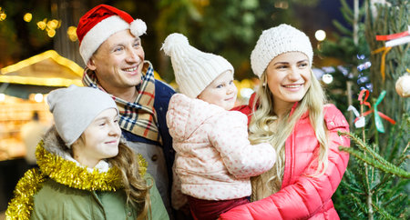 Happy family choosing Christmas treeの写真素材