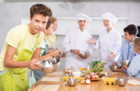Teenage boy learns to cook at master classの写真素材