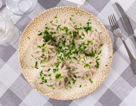 There is portion of khinkali on plate - national Georgian dish made of dough and meatの写真素材