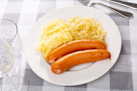 Sausages served with potatoes and cabbage