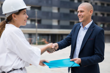 Real estate manager shaking hands with manの写真素材