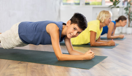 Family in training doing plank exercise to strengthen all abdominal muscle groups