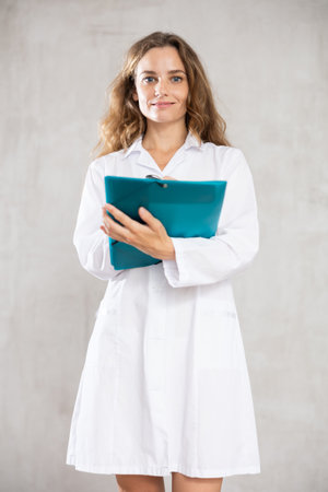 Young female doctor taking notes in studioの写真素材
