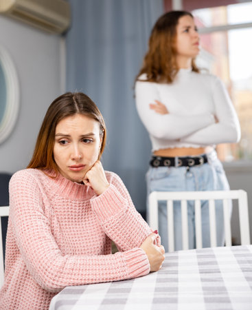 Two sisters do not want to communicate after domestic quarrel at homeの写真素材