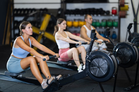 Young woman exercising on rowing machineの写真素材