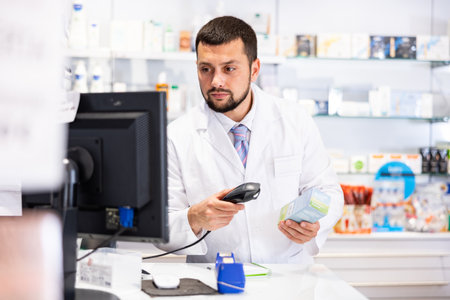 Friendly man pharmacist working at cash deskの写真素材