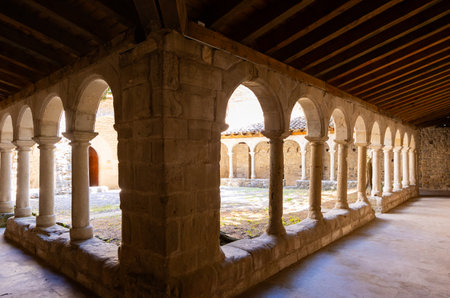 Shaded arched gallery around courtyard at Sant Llorenc de Morunys monasteryの写真素材