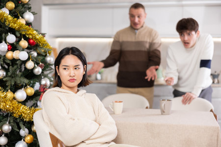 Adult and young man quarreling with young womanの写真素材