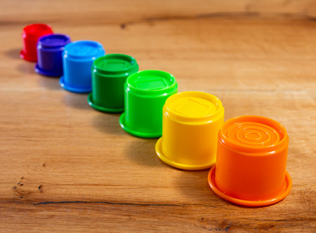 Childrens toy plastic cup pyramid made of multicolored elementsの写真素材