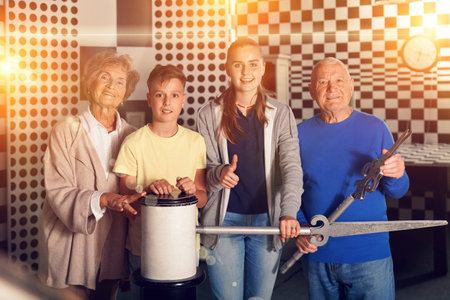Pensive elderly grandparents together with their children solve a puzzle in quest room